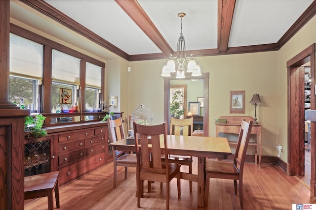 dining room featuring light wood-style floors, an inviting chandelier, beam ceiling, and crown molding