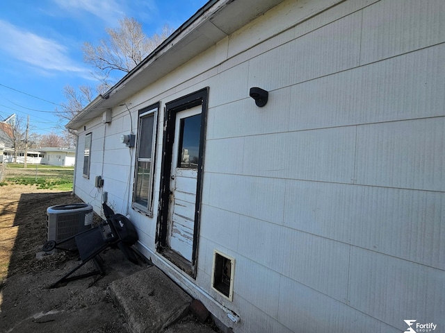 view of side of property with central AC unit