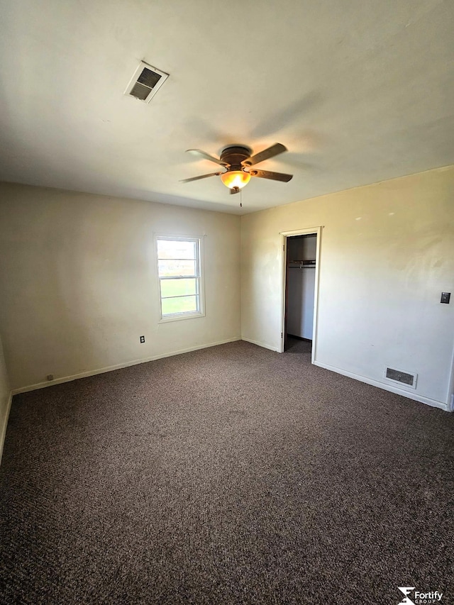 unfurnished room with a ceiling fan, visible vents, and baseboards