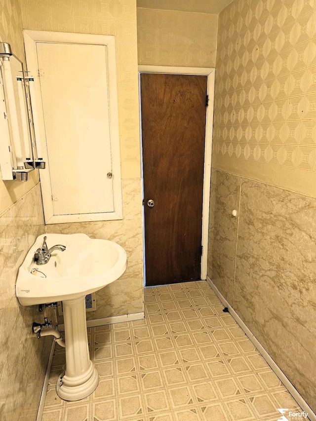 bathroom with wallpapered walls