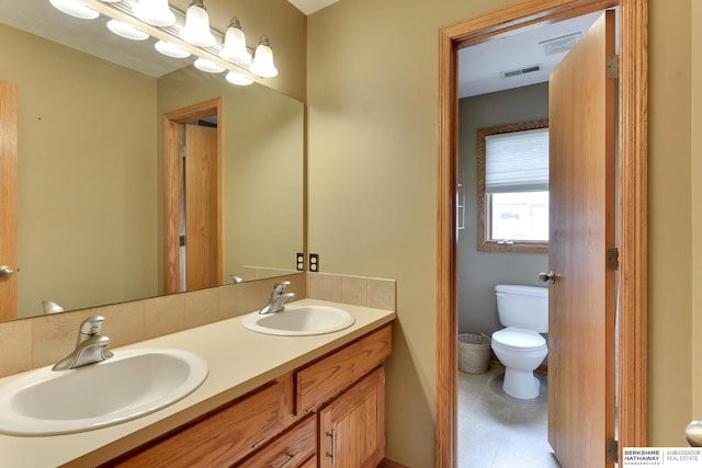 full bath with visible vents, a sink, tile patterned flooring, and toilet