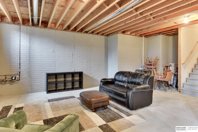 living area featuring stairs and concrete floors