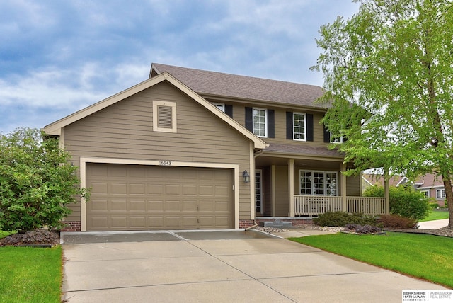 view of front of property featuring roof with shingles, a front lawn, a garage, a porch, and driveway