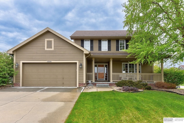 traditional home with concrete driveway, an attached garage, covered porch, and a front yard