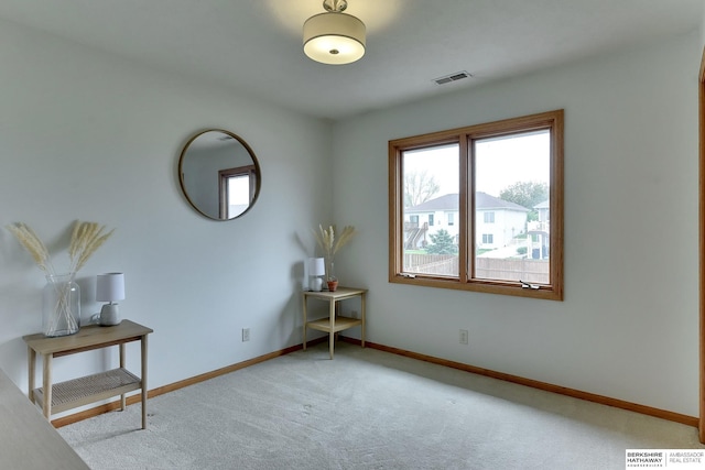 interior space with baseboards, visible vents, plenty of natural light, and carpet
