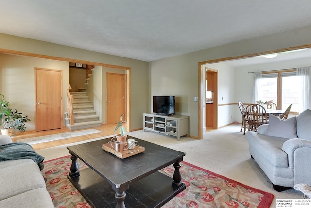 living area with baseboards and stairs