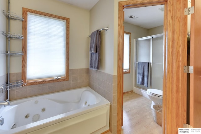 full bathroom with a jetted tub, visible vents, a shower stall, wood finished floors, and toilet