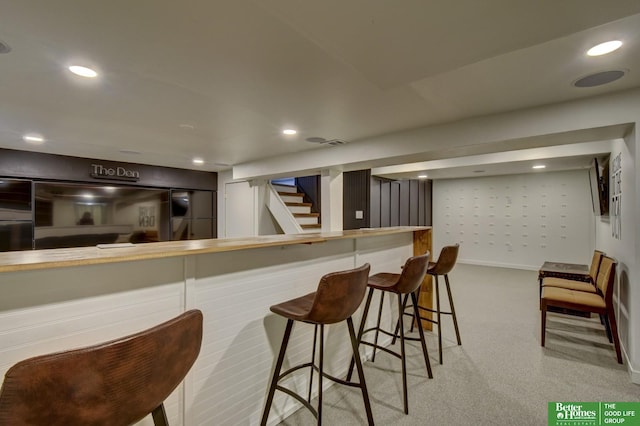 bar with recessed lighting, carpet flooring, and a dry bar