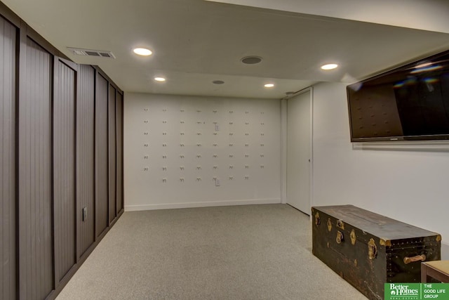 below grade area with baseboards, visible vents, carpet, and recessed lighting