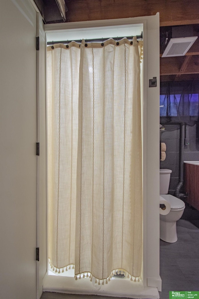 full bathroom with toilet and visible vents