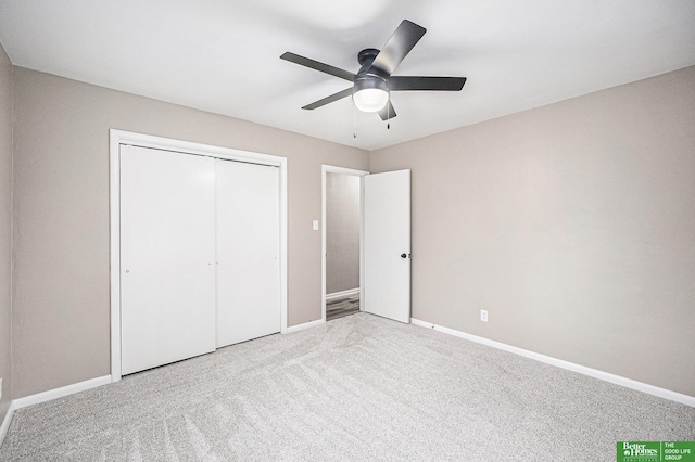 unfurnished bedroom with a closet, a ceiling fan, carpet floors, and baseboards