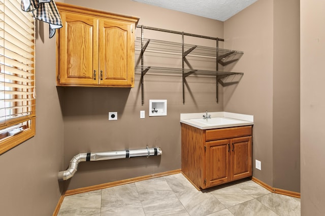 clothes washing area with cabinet space, washer hookup, electric dryer hookup, baseboards, and a textured ceiling