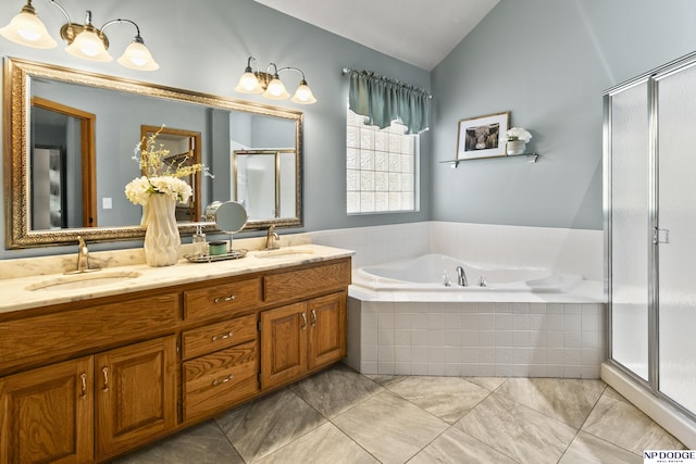 bathroom featuring lofted ceiling, a bath, a stall shower, and double vanity