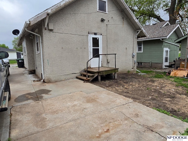 back of house featuring stucco siding and a patio area