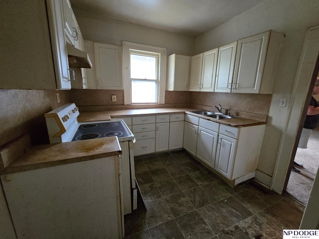 kitchen with electric stove, white cabinets, under cabinet range hood, and a sink