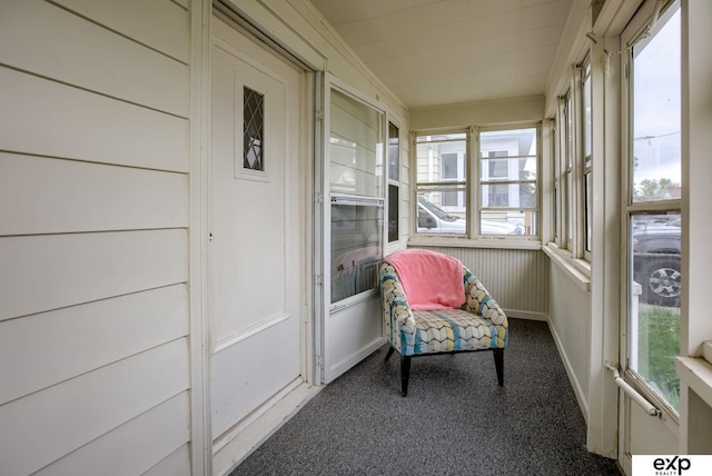 sunroom / solarium featuring carpet flooring