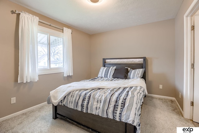 carpeted bedroom featuring baseboards