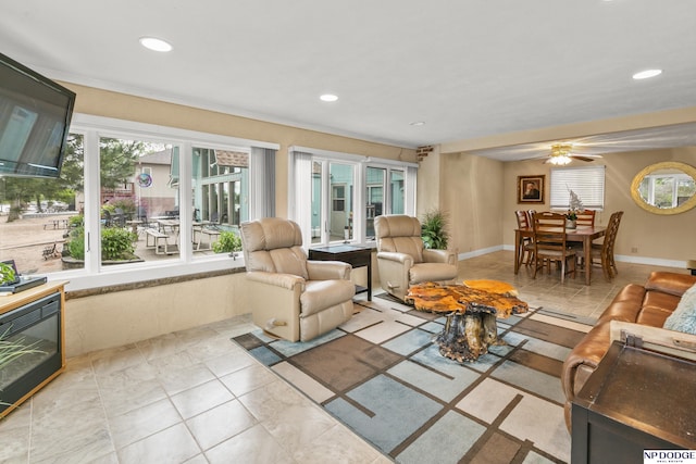 living area with a ceiling fan and recessed lighting