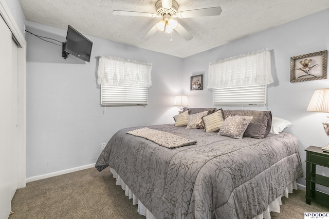 carpeted bedroom with a closet, a textured ceiling, baseboards, and ceiling fan