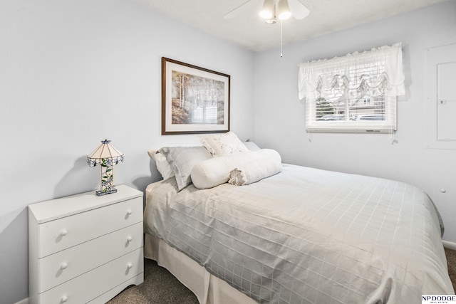 bedroom with a ceiling fan and dark carpet