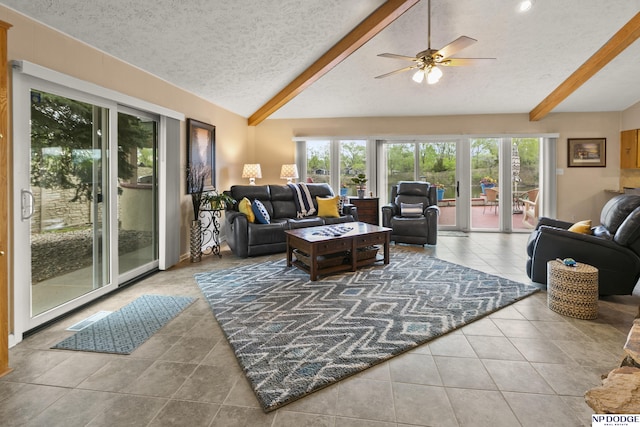 tiled living room featuring a textured ceiling, lofted ceiling with beams, and plenty of natural light
