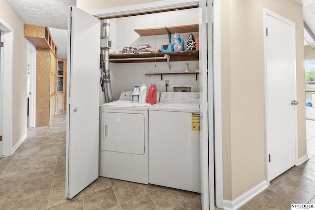 washroom with washing machine and clothes dryer and laundry area