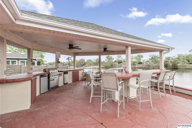 view of patio featuring exterior kitchen, ceiling fan, and outdoor wet bar