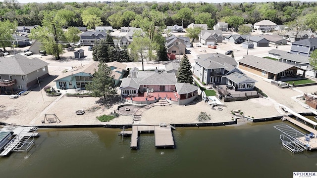 drone / aerial view featuring a water view and a residential view