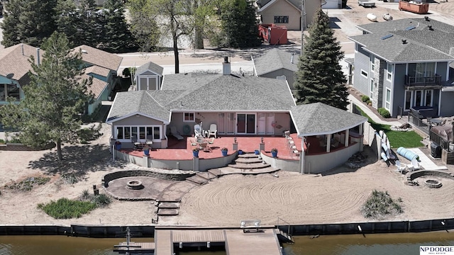 drone / aerial view featuring a water view and a residential view