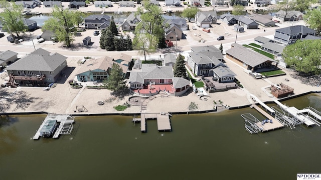 birds eye view of property with a water view and a residential view