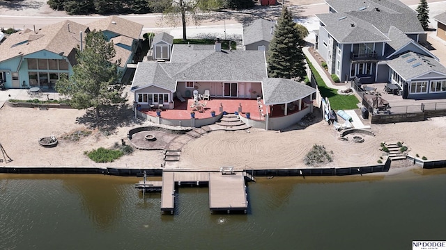 birds eye view of property with a water view and a residential view