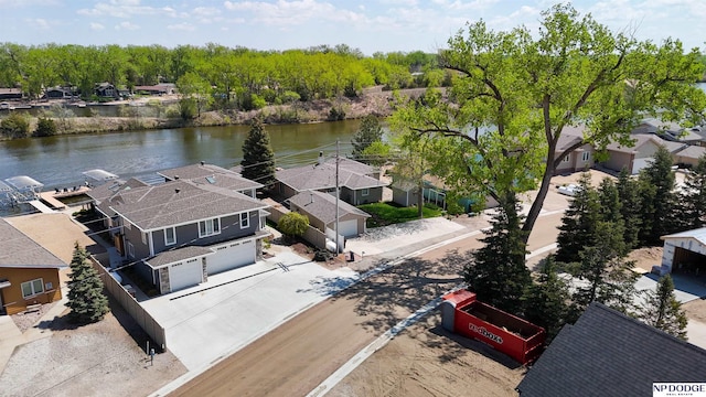 birds eye view of property featuring a water view and a residential view