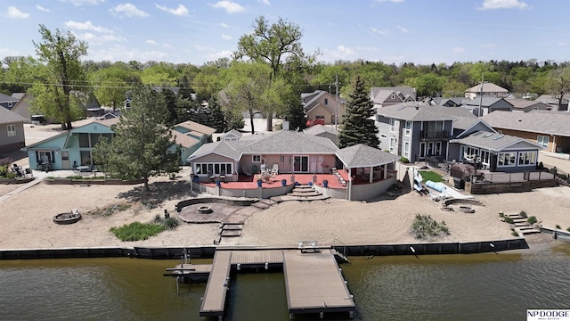 birds eye view of property with a water view and a residential view
