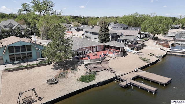 birds eye view of property with a water view and a residential view
