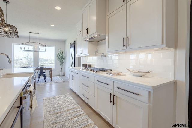 kitchen featuring recessed lighting, backsplash, white cabinetry, and stainless steel appliances