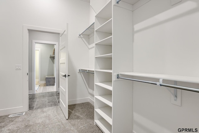 spacious closet with carpet flooring and visible vents