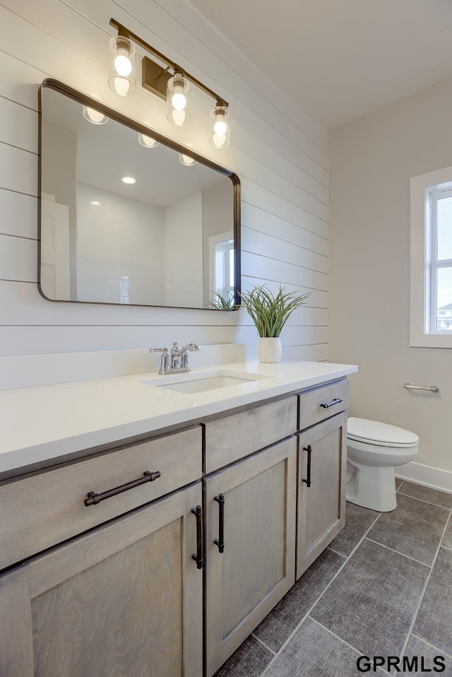 bathroom featuring tile patterned floors, toilet, and vanity