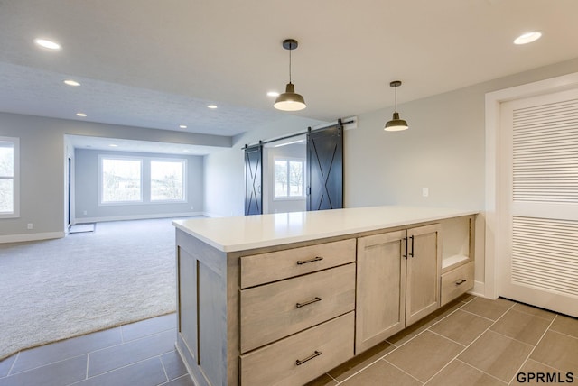 kitchen with recessed lighting, a barn door, open floor plan, a peninsula, and light colored carpet