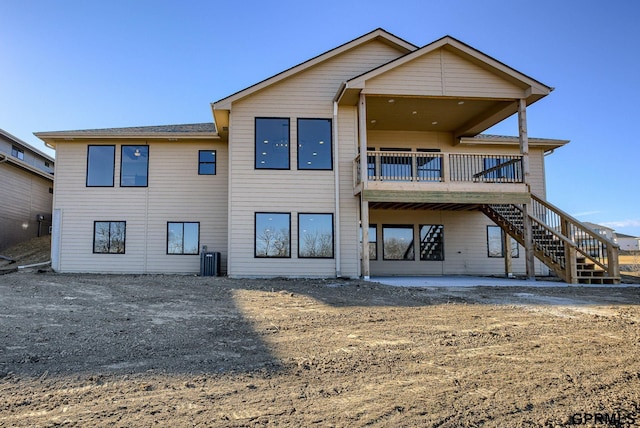 rear view of house with a deck, central air condition unit, and stairway