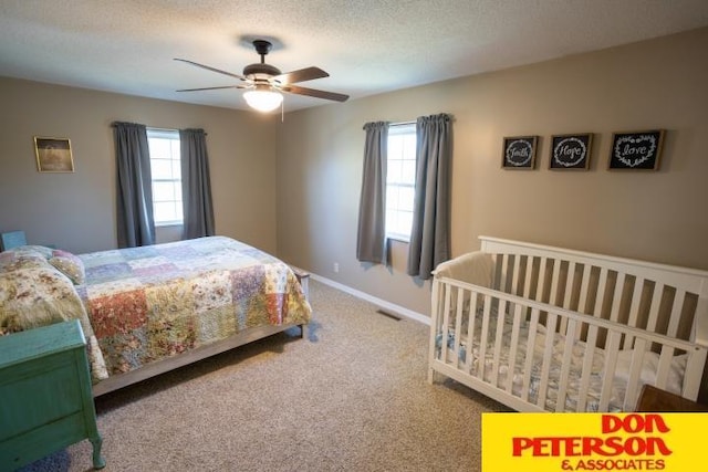 bedroom featuring carpet flooring, a ceiling fan, baseboards, and multiple windows
