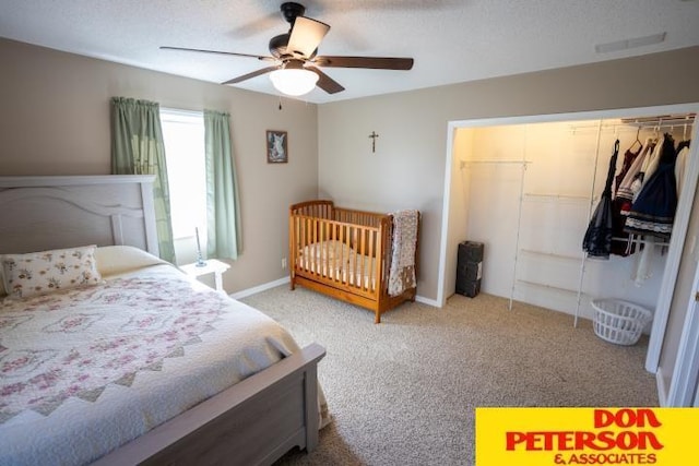carpeted bedroom with baseboards, ceiling fan, and a closet