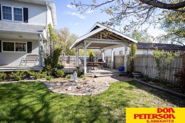view of yard with a gazebo, a wooden deck, and a fenced backyard