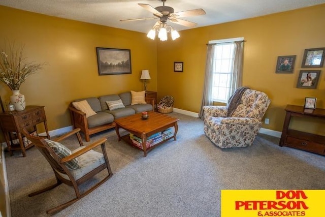 carpeted living area featuring ceiling fan and baseboards