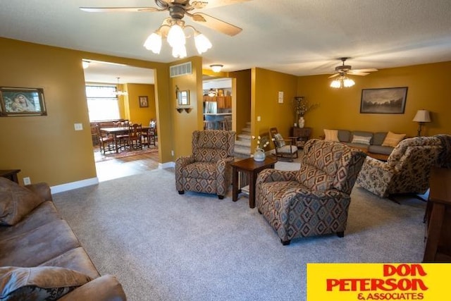 carpeted living area with ceiling fan, visible vents, and baseboards