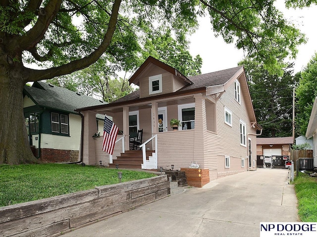 3615 N 60th St, Omaha, NE 68104 - bungalow-style home with a porch, a front yard, and an outbuilding