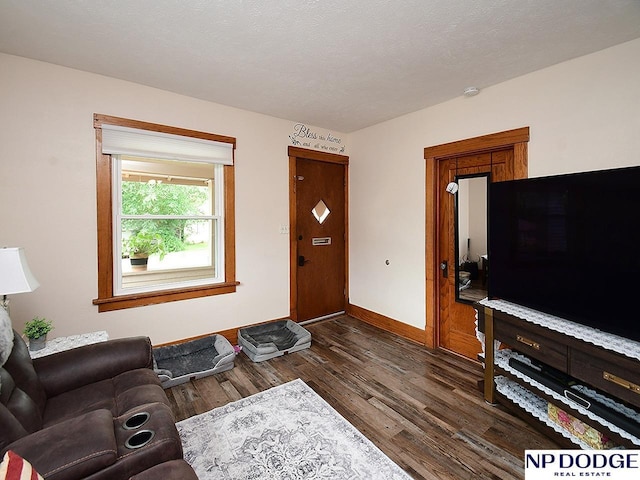 3615 N 60th St, Omaha, NE 68104 - living area featuring dark wood finished floors and baseboards