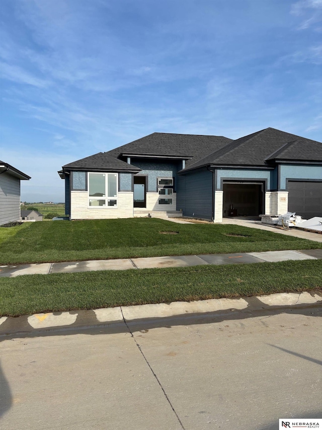 5614 212th St, Elkhorn, NE 68022 - prairie-style house featuring an attached garage, a front lawn, and a shingled roof