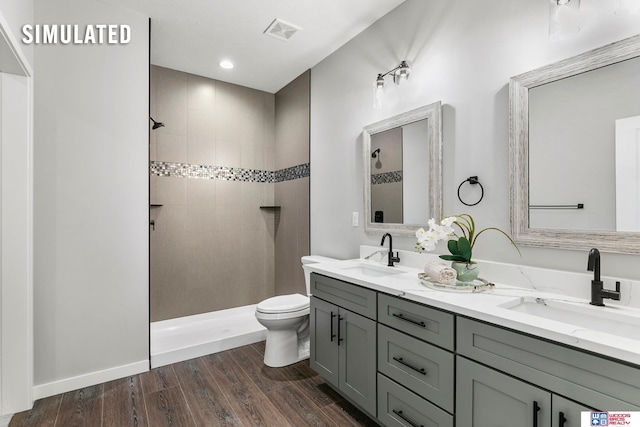full bath with a sink, walk in shower, and visible vents