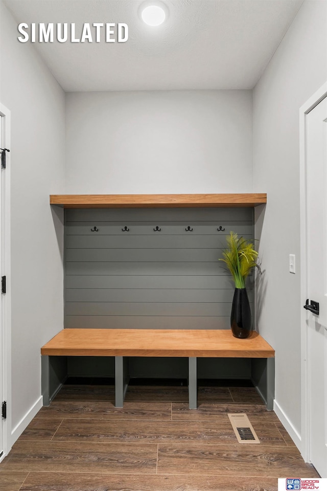 mudroom with visible vents, dark wood finished floors, and baseboards