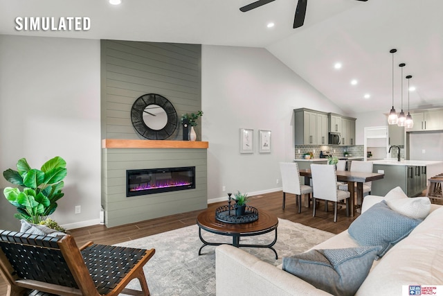 living room with high vaulted ceiling, ceiling fan, recessed lighting, and wood finished floors